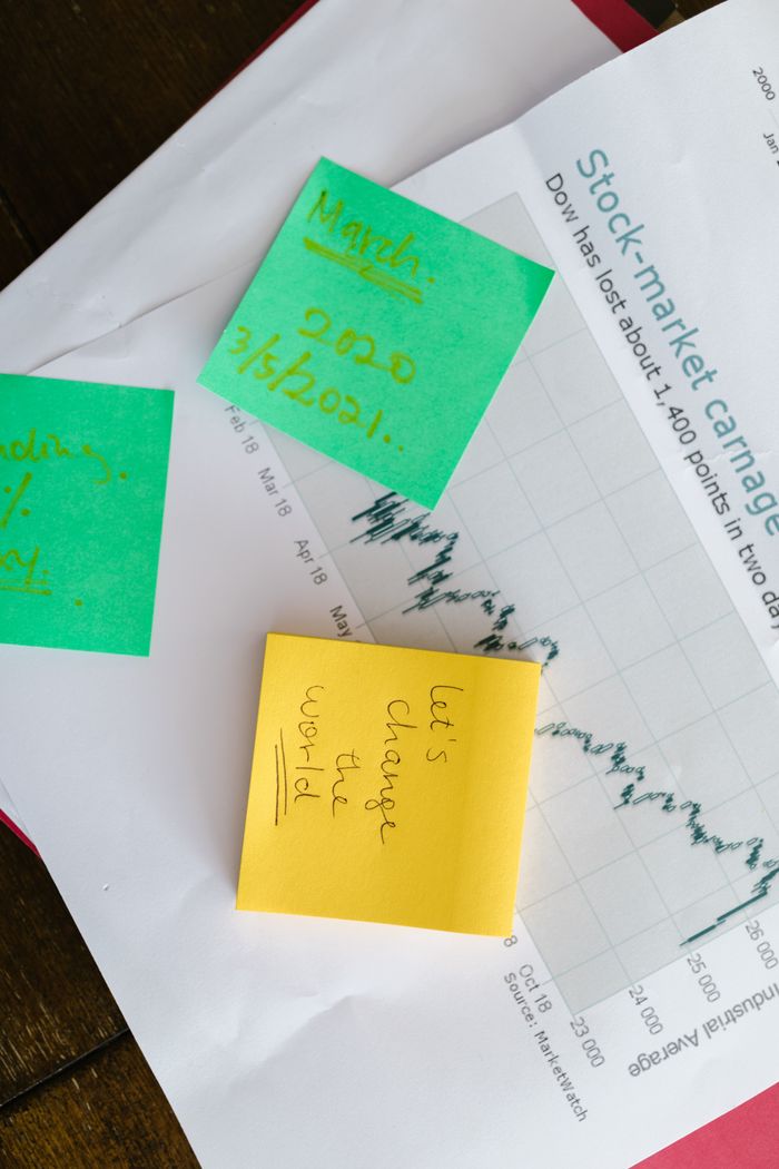 why-choose-us Top-view of colorful sticky notes on a stock market graph paper, symbolizing business and financial planning.