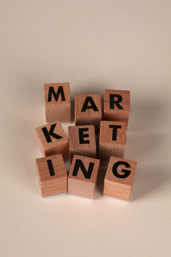 Services-01 Wooden blocks arranged to spell MARKETING on a neutral background.